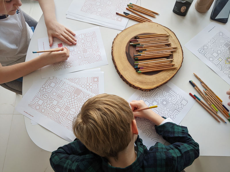 Child Coloring an Infinite Coloring Book Pattern
