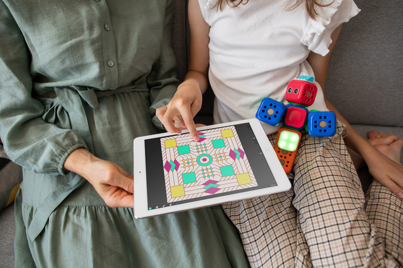 A mother and daughter coloring in a pattern made using the infinite coloring book